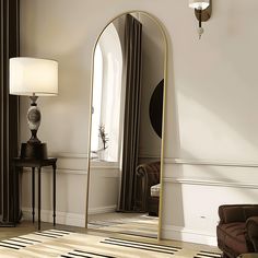 a large mirror sitting on top of a wooden floor next to a chair and lamp