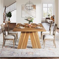 a dining room table with chairs and a vase on the centerpiece in front of it