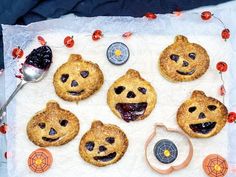 several cookies with faces are arranged on a piece of paper