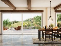 a dining room with sliding glass doors that open up to the patio and outside area