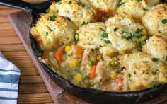 a pan filled with food sitting on top of a wooden table