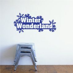 a metal step stool sitting in front of a wall with the words winter wonderland on it