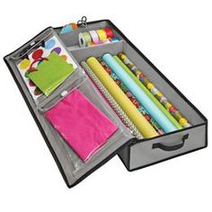 an open suitcase filled with lots of crafting supplies on top of a white background