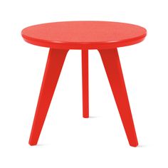 a red table sitting on top of a white floor