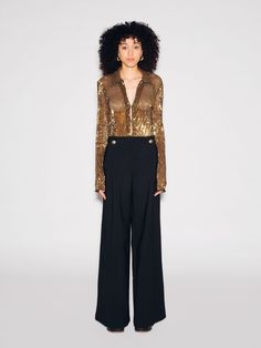 Inherently glamorous, our Pleated Sequin Mesh is integral to our eveningwear collection. For Fall 23, this unique fabric is crafted of black mesh overlaid with gold sequins for a dimensional two-tone effect; the slim tailored shirt silhouette offers a refined counterpart to the statement fabric. Featuring fine pleating with allover sequin embroidery, Rosetta Getty's Pleated Sequin Mesh fabrication is an evening staple. Offered in quintessential silhouettes, it offers alluring dimension and spark Luxury Tops For Night Out, Luxury Gold Tops For Evening, Luxury Gold Top For Evening, Glamorous Gold Formal Tops, Evening Long Sleeve Embellished Mesh Top, Luxury Fitted Gold Top, Gold Fitted Luxury Top, Metallic Tshirt Sewuin, Luxury Long Sleeve Sequin Shirt