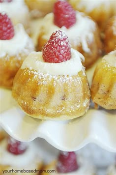 small pastries with raspberries are on a white plate