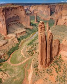 an aerial view of canyons and cliffs in the desert with water running through them