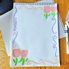 two notebooks on a wooden table with markers and pens next to them, along with an empty notepad