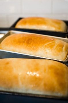 three loafs of bread sitting on top of a stove