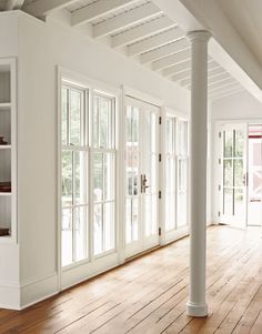 an empty living room with white walls and wood floors is pictured in this image from the inside