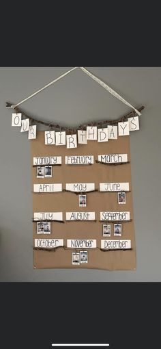 a bulletin board with words and pictures hanging from it's sides on a wall