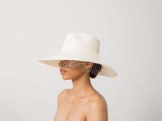 Long Brim Aguacate Hat with Tulle 100% Toquilla straw. This natural fiber is known for its quality and beauty. The perfect beach-to-city accessory. Each hat takes approximately two to three days to weave by hand by our Ecuadorian artisans, and after pressed for shape. Indulge in luxurious style with our handmade Long Brim Aguacate Hat. Crafted from premium toquilla straw and adorned with delicate tulle, this hat is the perfect addition to your wardrobe. The long brim provides elegant sun protection while the aguacate design adds a touch of sophistication. -We ship with DHL Express. Shipping takes approximately 3 to 5 days to arrive depending on the destination. -Need Help? Please contact: customercare@sensistudio.com -All Sales Are Final. Wedding Hats For Bride, Derby Day Outfits, Funeral Hats, Black Hat Outfit, Wedding Guest Hat, Wedding Hats For Guests, Bridal Hats, Derby Outfits, 2025 Wedding