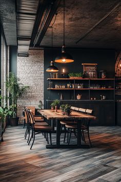 an industrial style dining room with wood flooring and brick walls, along with potted plants