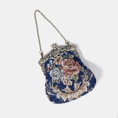 Introducing our captivating collection of Chatelaine purses, inspired by the elegance of the Victorian era.Available in three sizes—Large, Medium, and Small—these purses offer versatility and style. The Large and Medium sizes can be used as both a clutch and a crossbody purse, as we provide two chains for each size: 50" and 13" in length. This allows you to effortlessly switch between crossbody and clutch styles.Let's focus on the Chatelaine Large Crossbody Purse:With a frame width of 6.25" and a height of 8", this purse comfortably holds larger items like the iPhone 14 Pro Max and a passport. It features a small slip pocket for cards or small essentials, and the 1.5" bottom depth provides ample space for your necessities.The Large Crossbody Purse includes two chains, each with brass hooks Elegant Floral Embroidered Top Handle Shoulder Bag, Elegant Top Handle Bag With Floral Print, Vintage Floral Embroidery Formal Bags, Blue Evening Flap Bag With Gold-tone Hardware, Large Crossbody Purse, Blue Vintage Bag With Gold-tone Hardware, Brass Hook, Secret Sale, Chatelaine