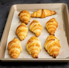 freshly baked croissants on a baking sheet ready to go into the oven