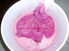 a pink substance in a white bowl on a table