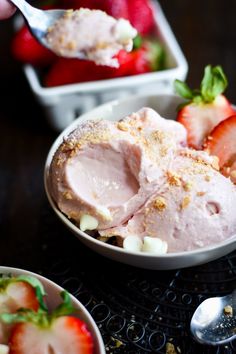 two bowls filled with ice cream and strawberries