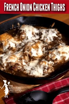 french onion chicken thighs in a cast iron skillet on a wooden table with red and white checkered napkin