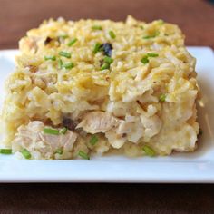 a white plate topped with rice and meat