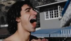 a man with his mouth open and tongue out