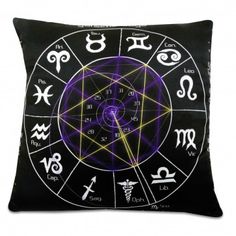 a black pillow with zodiac signs on it