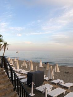 lounge chairs and umbrellas are on the beach