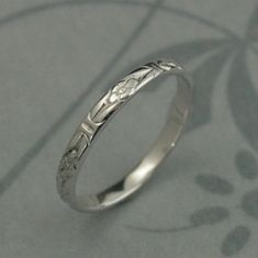 a silver ring with an intricate design on it