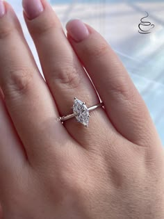 a woman's hand with a diamond ring on it