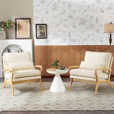 two chairs sitting next to each other on top of a rug in a living room