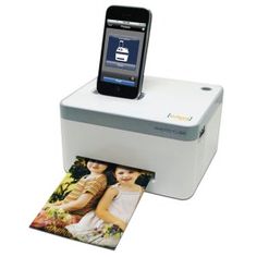 an iphone is sitting on top of a printer with the image of two children in it