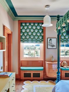 a bedroom with pink walls and blue curtains