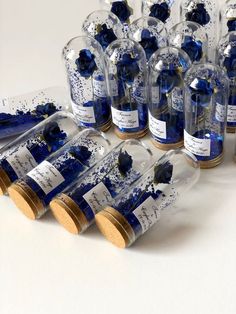 many bottles with blue and white splatters in them