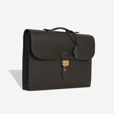 When fashion meets function and the business-chic meets low-key luxury, you get the Hermès Sac à Dépêches. The ultimate go to for any business man on the go with a love for luxury, Hermès presents their stunning briefcase in Brown. Carefully crafted from durable Vache Liegee leather, the Sac à Dépêches is ideal for the working man with a lot to carry. SPL Exterior Ebene Vache Liegee Leather Gold hardware One top handle Single flap Push lock buckle closure Excellent condition - some hardware scratches Interior Cowhide interior Three compartments Two slip pockets at the back Additional mobile phone pocket Great condition - some light interior markings Sold with box, dustbag and keys SPL Height 29cm Width 38cm Depth 7cm Business Chic, Prada Crossbody, Dior Shoes, Prada Crossbody Bag, Chanel Handbags, Low Key, A Love, Business Man, Gold Hardware