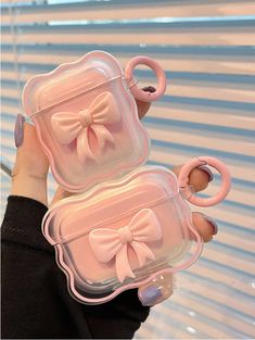 two pink bows are attached to the lids of these cute little cases, both with handles