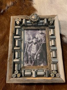 an old photo frame sitting on top of a fur covered floor