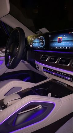 the interior of a modern car with blue lights