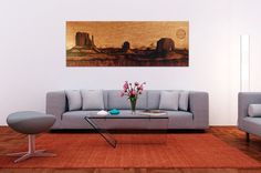 a living room with two gray couches and a painting on the wall above them