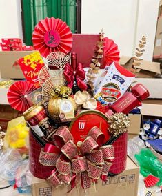 a gift box filled with chocolates, candy and other holiday treats sitting on top of a table