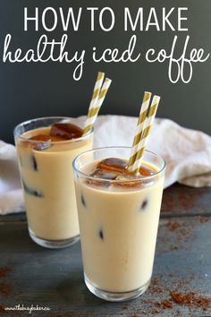 two glasses filled with iced coffee on top of a table