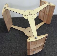 an airplane made out of wood sitting on the floor