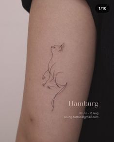 a woman's arm with a cat tattoo on the left side of her body