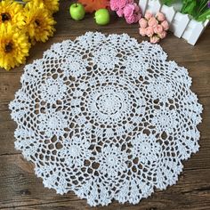 a white doily sitting on top of a wooden table