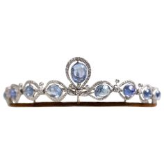 A vintage sapphire and diamond convertible tiara necklace. An exceptional vintage sapphire and diamond convertible tiara and necklace set, in platinum, circa 1950. This beautifully handcrafted tiara is easily transformed into necklace by simply unclipping it from its frame, no additional screws or parts are needed! The tiara is composed of nine cabochon cut sapphires, each individually bezel set within an elegant diamond scrolled cluster surround, providing a beautiful amount of sparkle to the j Convertible Tiara, Sapphire Tiara, Diamond Crown, Royal Tiaras, Vintage Sapphire, Diamond Tiara, Silver Crown, Cabochon Jewelry, Unusual Jewelry