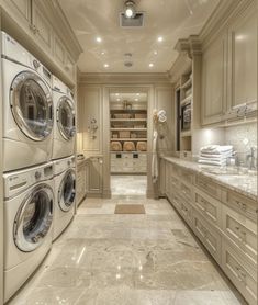 a large laundry room with washers and dryers