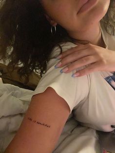 a woman with a tattoo on her arm that reads, i'm not married