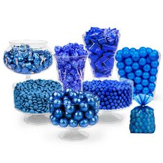 blue candies and candy in glass bowls on white background with clear vases filled with them