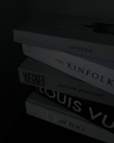 a stack of books sitting on top of each other in front of a black background