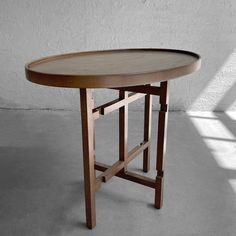 a wooden table sitting on top of a cement floor