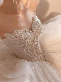 the back of a wedding dress with beading and sequins is shown in close up