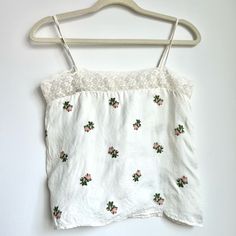 New With Tags. Floral Embroidery & Lace Details. Button Back Closure. Size Fr 34/Us 2. Feminine Embroidered White Tops, White Cotton Embroidered Top With Lace Trim, White Embroidered Top With Lace Trim, Vintage White Embroidered Summer Top, Vintage White Embroidered Top For Summer, Feminine White Embroidered Top, White Fitted Feminine Embroidered Top, Feminine Fitted White Embroidered Top, Feminine White Fitted Embroidered Top